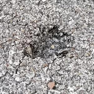 Motorcycle kickstand sink on pavement